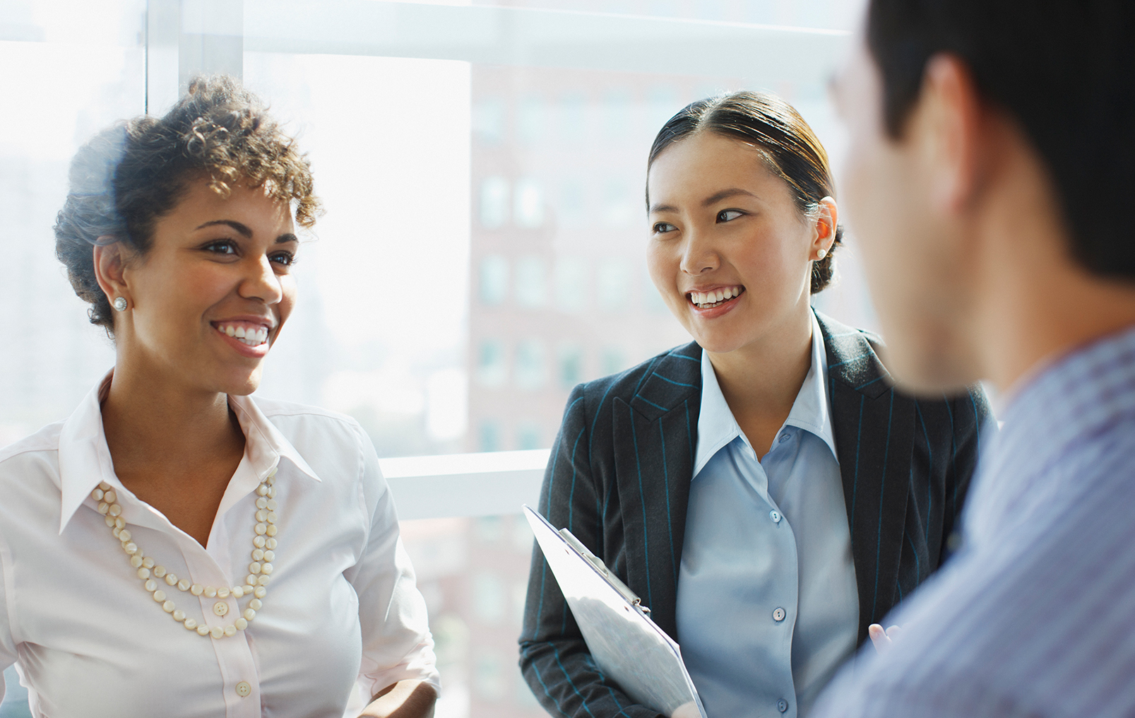 Three employees talking