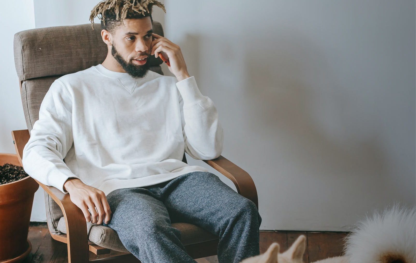 Man sitting in chair on the phone