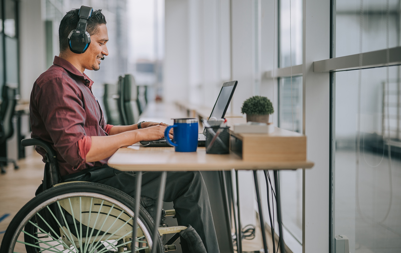 man in wheelchair at desk