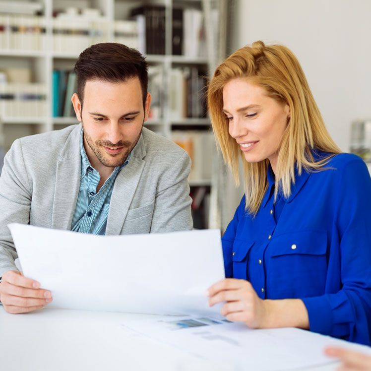 man and woman reviewing a document